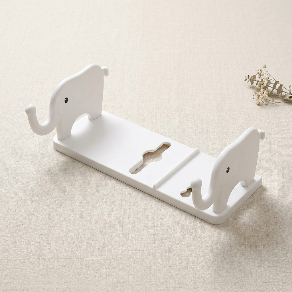 White elephant-shaped wall shelf arranged on cream linen
