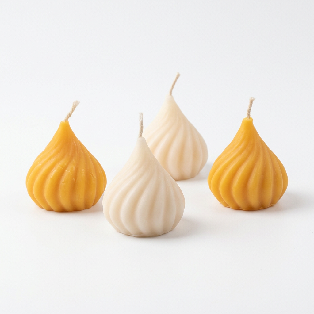 Pack of four spiral teardrop candles on white background